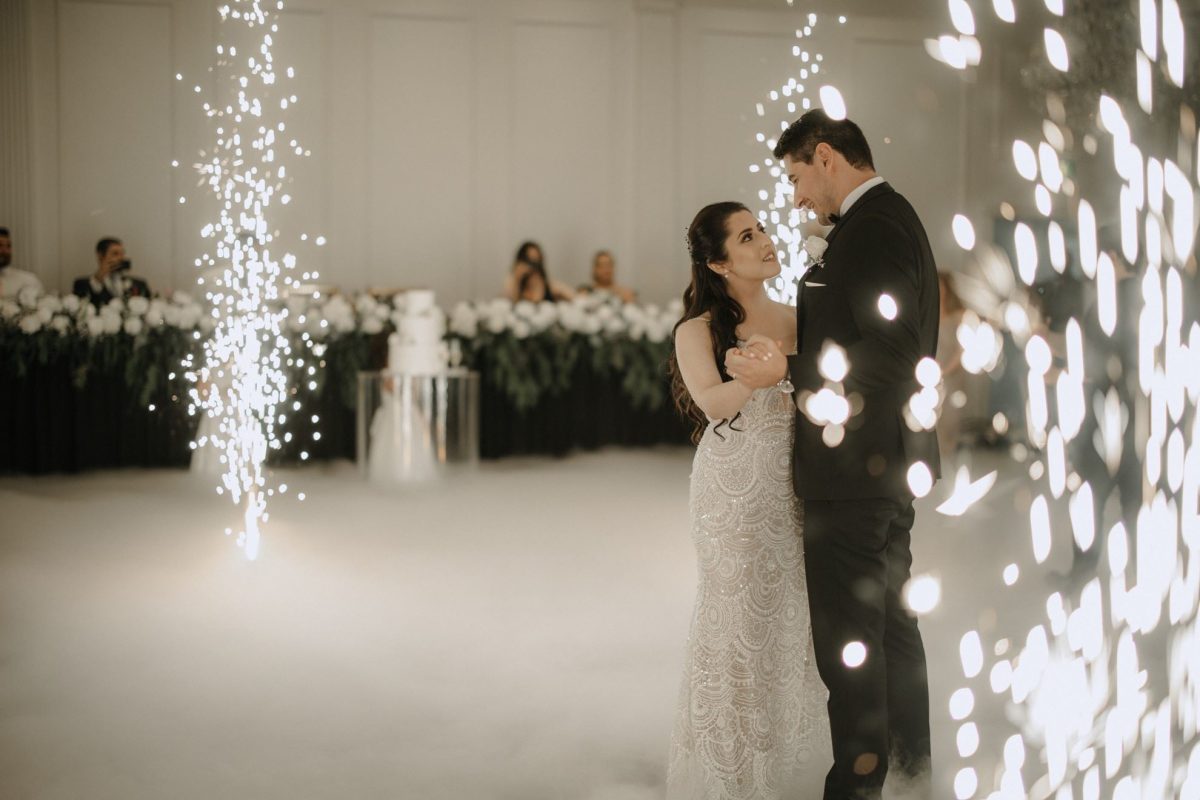 Newlyweds having first dance in front of 600 guests